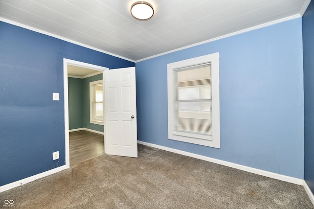 carpeted spare room featuring ornamental molding