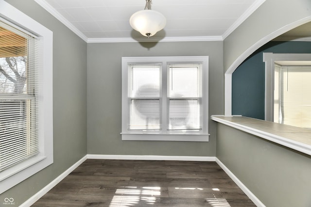 unfurnished dining area with dark wood-type flooring and ornamental molding