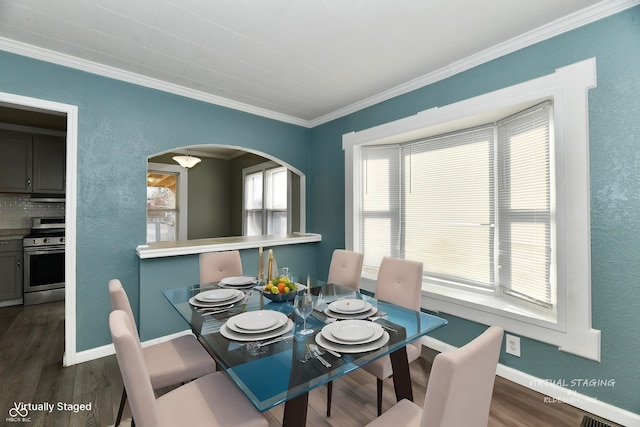 dining room with ornamental molding and dark hardwood / wood-style floors