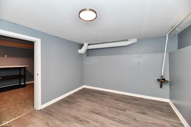 basement with hardwood / wood-style floors