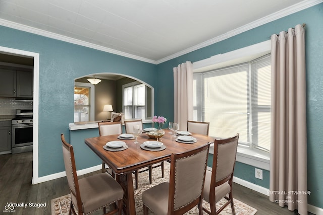 dining space with ornamental molding and dark hardwood / wood-style floors