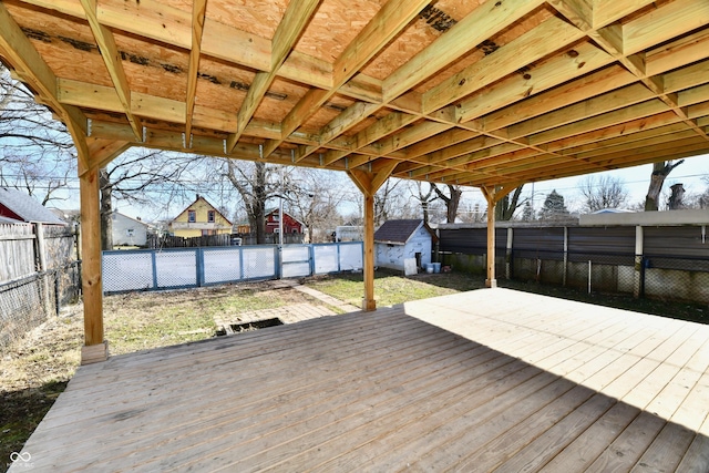 wooden terrace featuring a storage unit