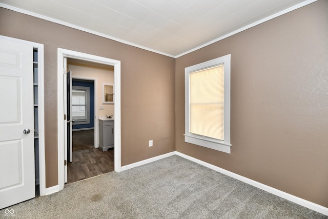 unfurnished bedroom featuring ornamental molding and carpet