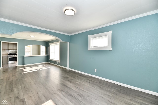 unfurnished living room featuring ornamental molding and light wood-type flooring