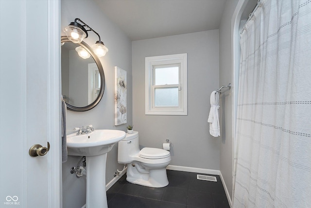 bathroom with tile patterned flooring, sink, and toilet