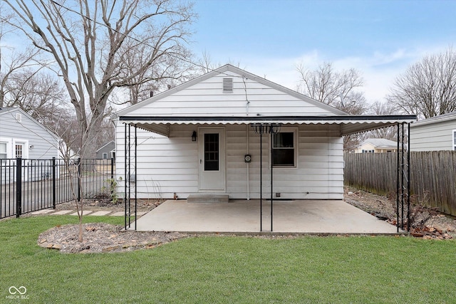 back of property featuring a lawn and a patio area