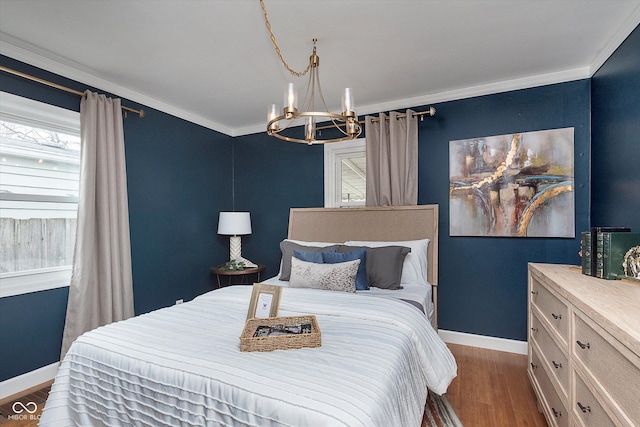 bedroom featuring dark hardwood / wood-style flooring, a notable chandelier, and ornamental molding