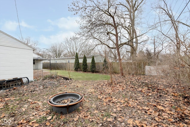 view of yard with a fire pit