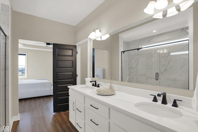 bathroom with wood-type flooring, vanity, ceiling fan, and a shower with shower door