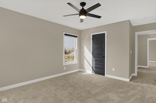 unfurnished bedroom featuring light colored carpet and ceiling fan