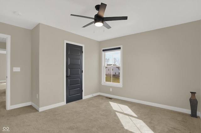 unfurnished bedroom featuring light colored carpet and ceiling fan