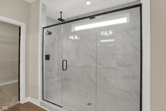 bathroom featuring hardwood / wood-style floors and walk in shower