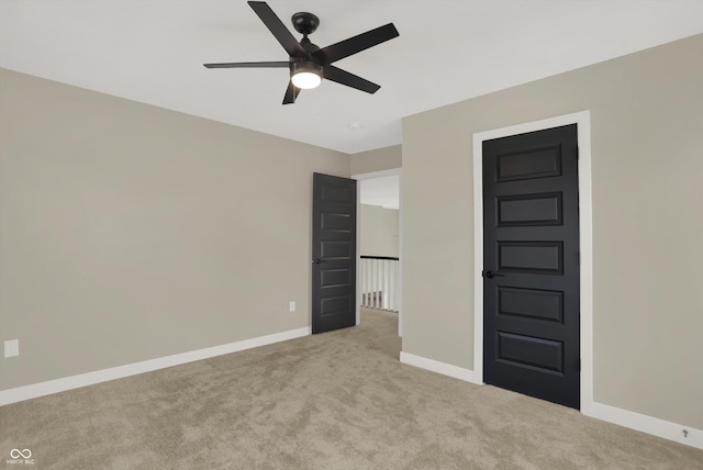 unfurnished bedroom featuring ceiling fan and light colored carpet