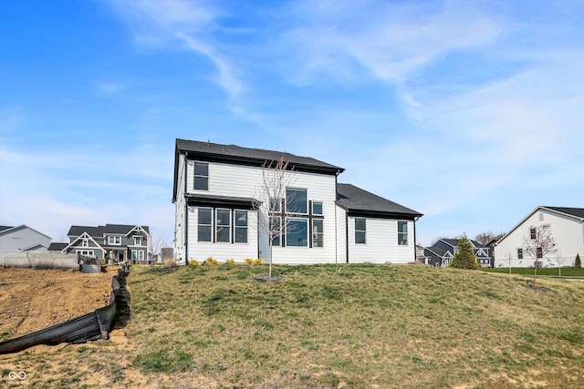 back of house featuring a lawn