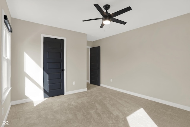 unfurnished bedroom featuring light carpet and ceiling fan