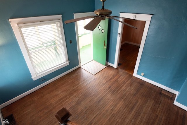 interior space featuring dark wood-type flooring and ceiling fan