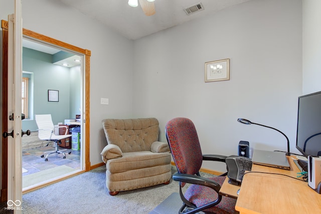 carpeted office space with visible vents, baseboards, and ceiling fan