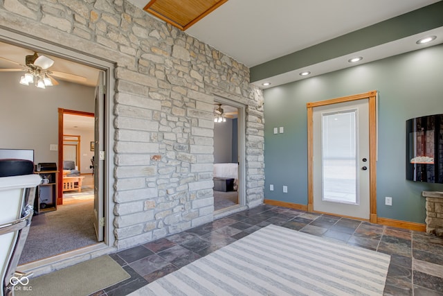 entryway with recessed lighting, a ceiling fan, baseboards, and stone tile flooring