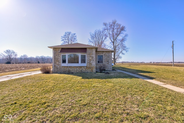 view of front of house with a front lawn and stone siding