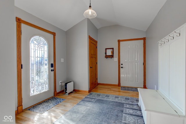 entryway with plenty of natural light, light wood-type flooring, and vaulted ceiling