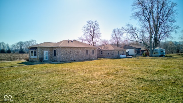 rear view of property with a lawn