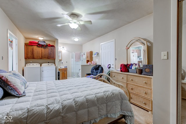 bedroom featuring ceiling fan, washer and clothes dryer, light colored carpet, ensuite bath, and a textured ceiling