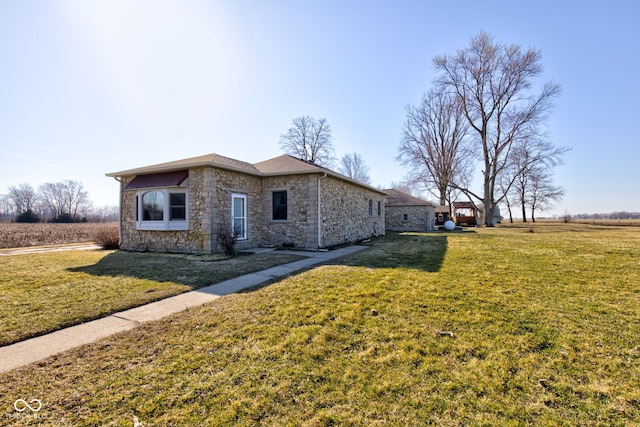 view of front of house featuring a front yard and stone siding