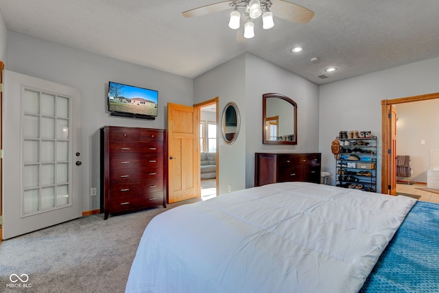 bedroom with a textured ceiling, ensuite bath, recessed lighting, carpet flooring, and ceiling fan