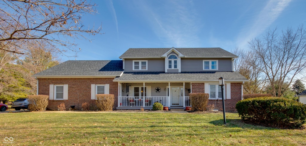 view of property with a front lawn and covered porch