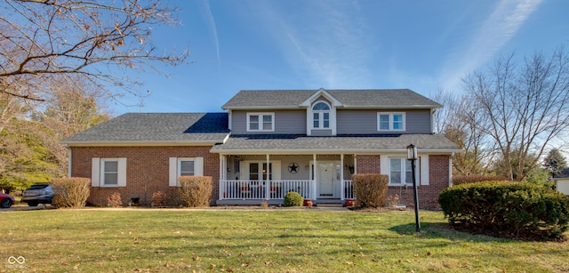 view of property with a front lawn and covered porch