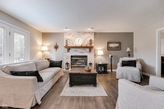 living room featuring hardwood / wood-style floors and a brick fireplace