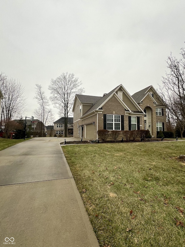 view of front of property with a garage and a front lawn