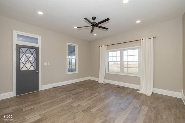 foyer entrance with hardwood / wood-style flooring and ceiling fan