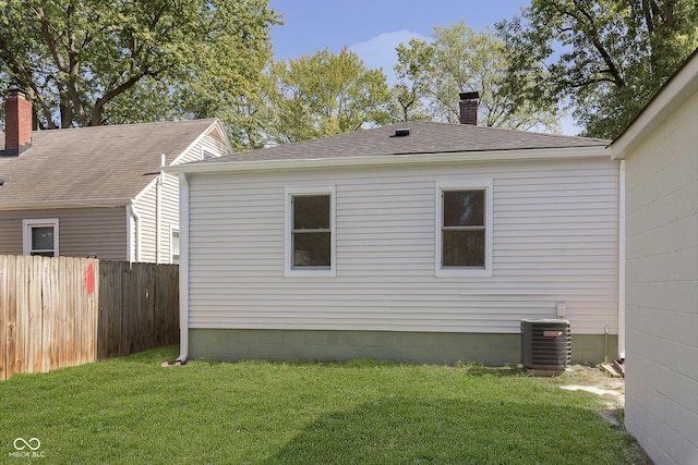 view of property exterior featuring central AC and a lawn