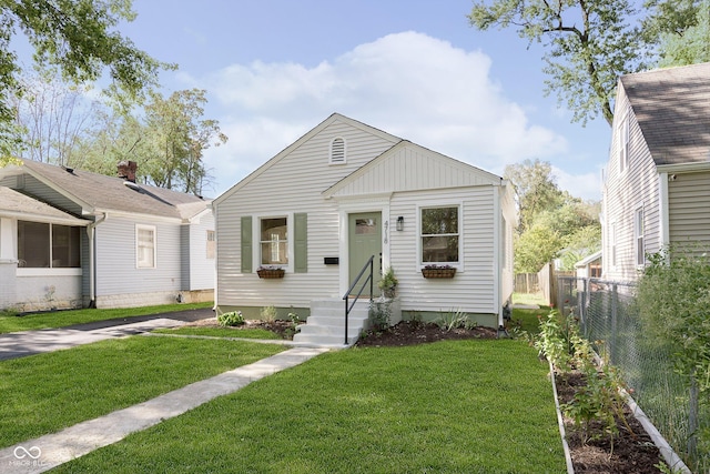 bungalow-style house featuring a front yard