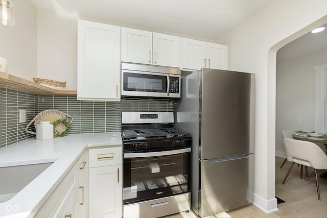 kitchen featuring stainless steel appliances and white cabinets