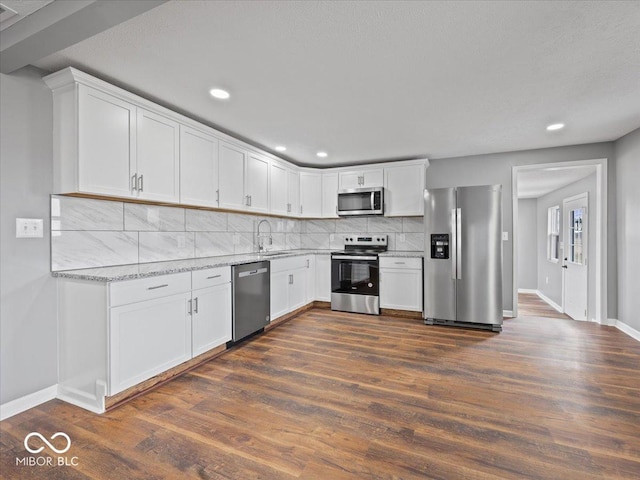 7279 W State Road 44, Shelbyville, IN 46176 - kitchen with light stone counters, dark wood-type flooring, white cabinets, and appliances with stainless steel finishes