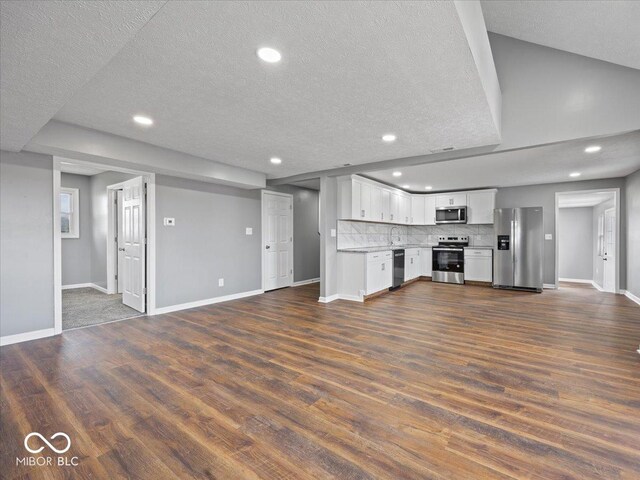 7279 W State Road 44, Shelbyville, IN 46176 - unfurnished living room featuring dark wood-type flooring and a textured ceiling
