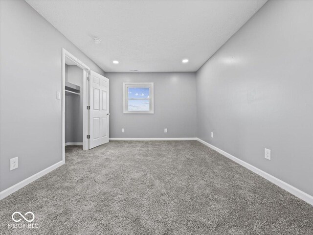 7279 W State Road 44, Shelbyville, IN 46176 - unfurnished bedroom with a spacious closet and carpet flooring