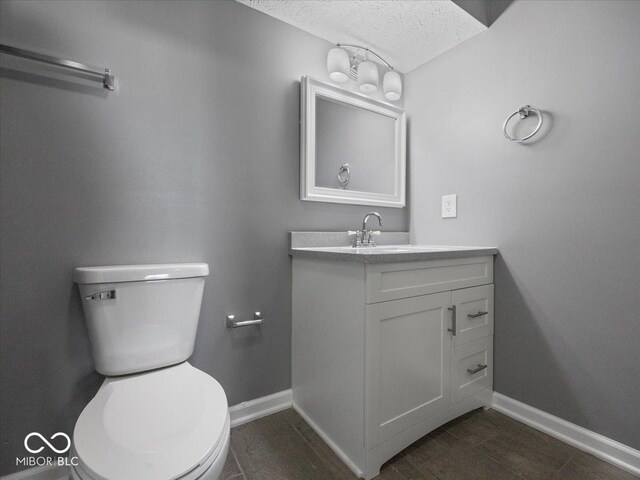 7279 W State Road 44, Shelbyville, IN 46176 - bathroom with vanity, a textured ceiling, and toilet