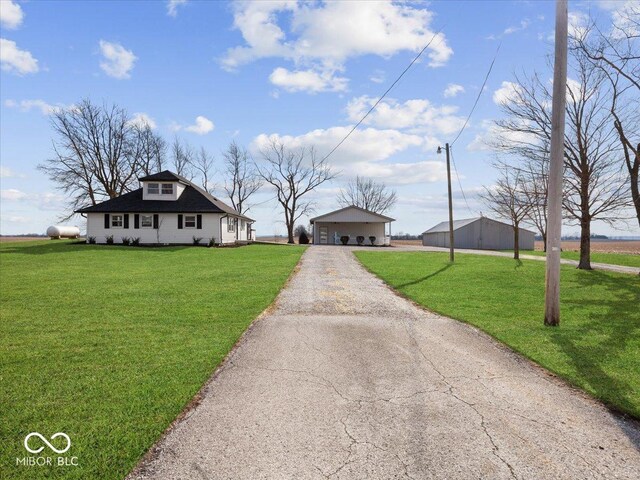 7279 W State Road 44, Shelbyville, IN 46176 - view of front of home featuring a garage, an outbuilding, and a front yard