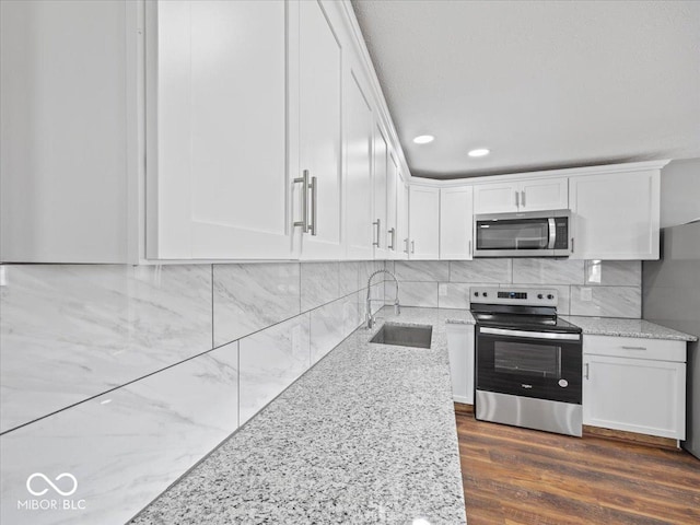 7279 W State Road 44, Shelbyville, IN 46176 - kitchen featuring sink, backsplash, stainless steel appliances, light stone counters, and white cabinets