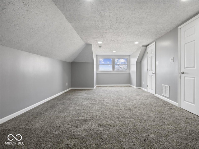 7279 W State Road 44, Shelbyville, IN 46176 - additional living space featuring lofted ceiling, carpet, and a textured ceiling