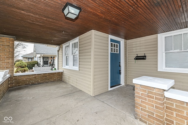 view of exterior entry with covered porch