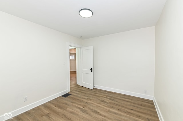 spare room featuring hardwood / wood-style floors