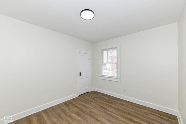 spare room featuring dark wood-type flooring