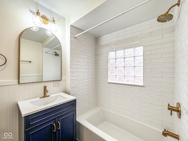 bathroom with tiled shower / bath and vanity