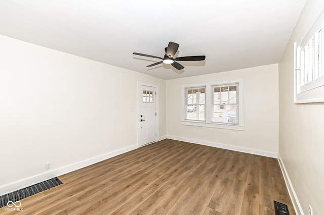 spare room with ceiling fan and dark hardwood / wood-style floors