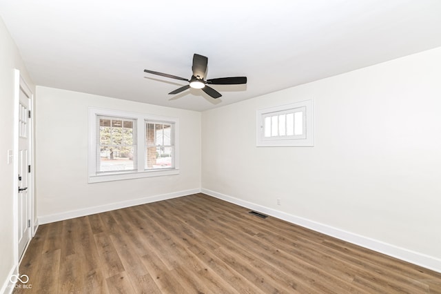 spare room with dark hardwood / wood-style floors and ceiling fan