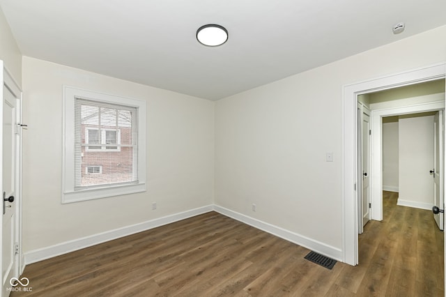 unfurnished bedroom featuring dark wood-type flooring